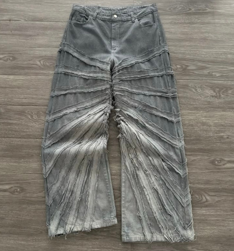 Distressed gray jeans on a wooden surface