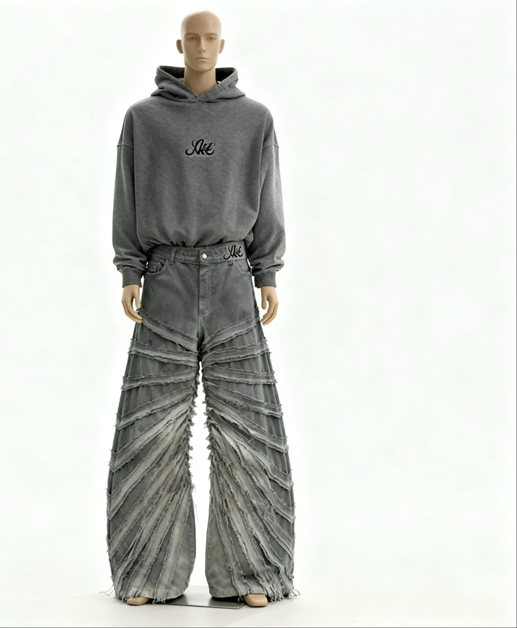 Mannequin wearing a gray hoodie and distressed jeans on a white background