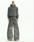 Mannequin wearing a gray hoodie and distressed jeans on a white background