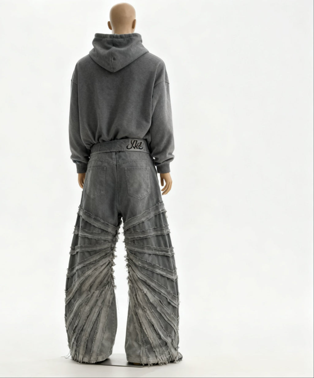 Mannequin wearing a gray hoodie and distressed jeans on a white background