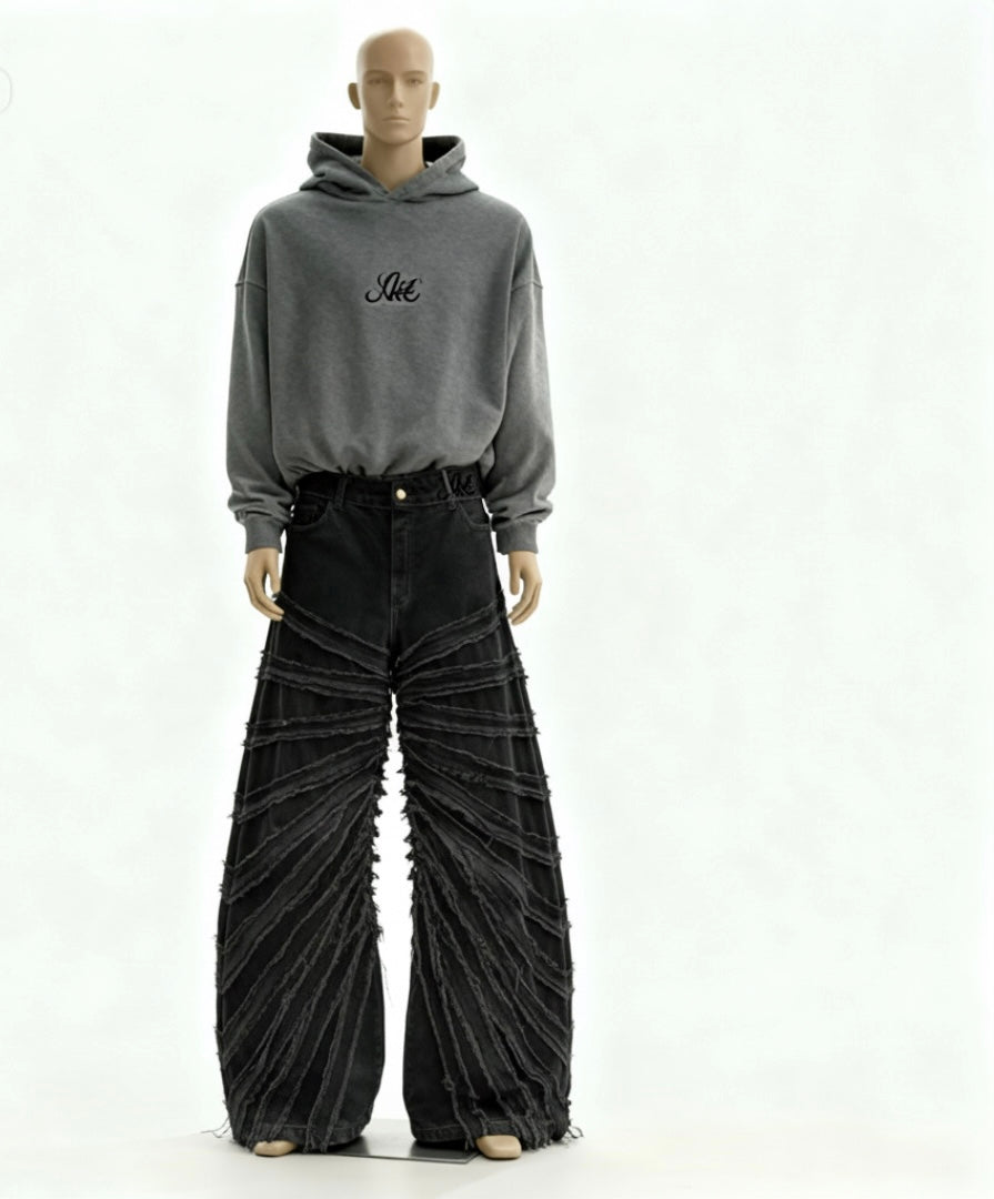 Mannequin wearing a gray hoodie with text and black pleated pants on a white background